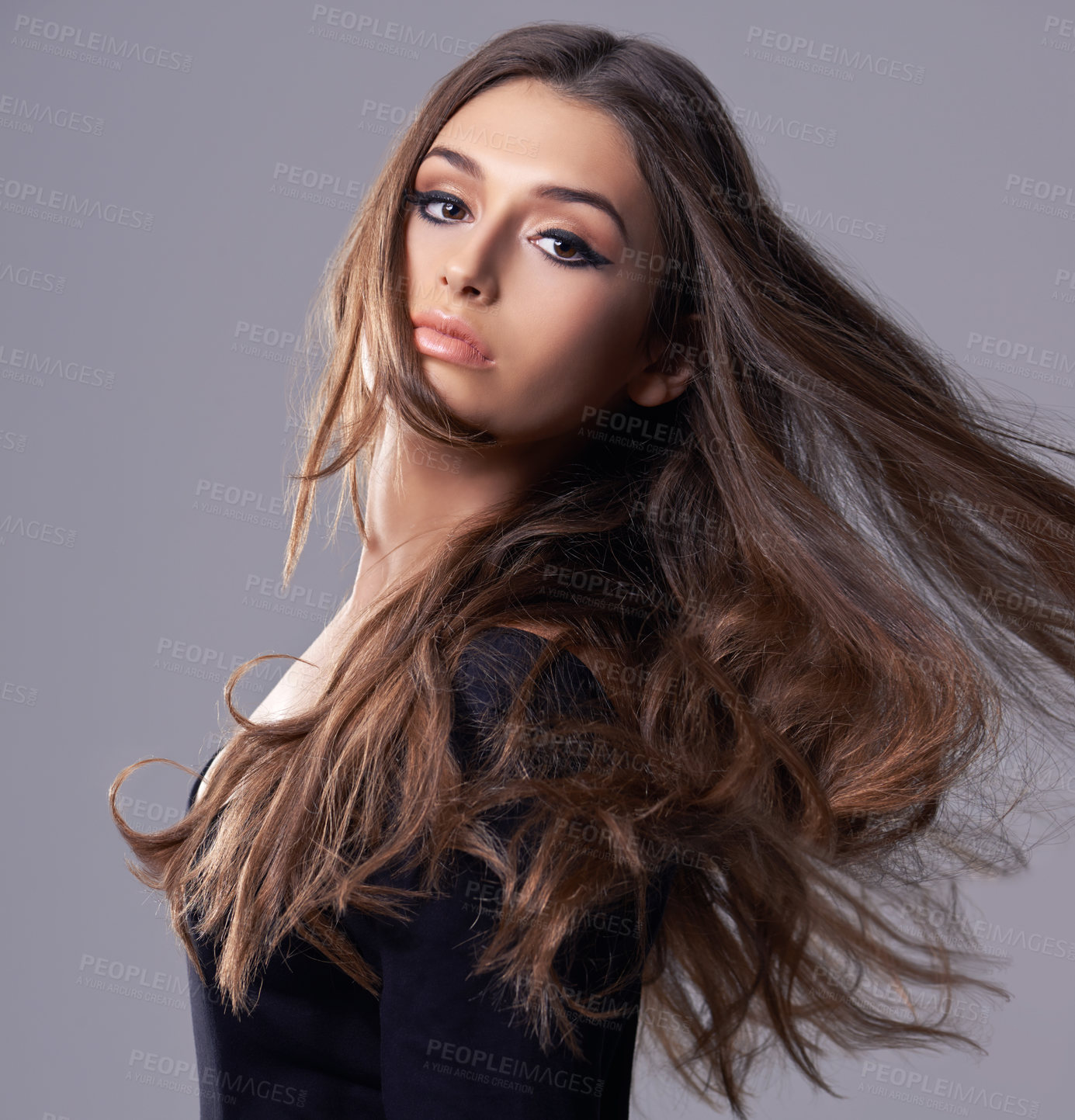 Buy stock photo Studio portrait of a gorgeous young woman against a gray background