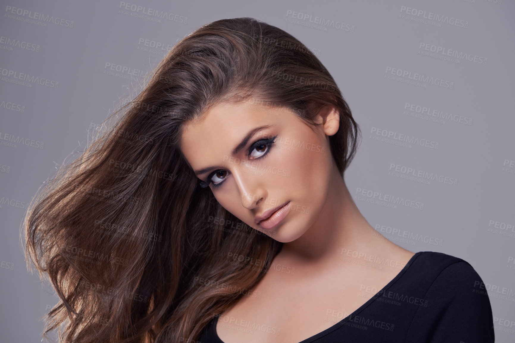 Buy stock photo Studio portrait of a gorgeous young woman against a gray background