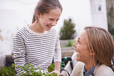 Buy stock photo Happy, mother and child in garden with plant, laughing or funny family bonding outdoor in summer. Mom, girl or smile with vegetables for agriculture at backyard or growth of organic food for learning