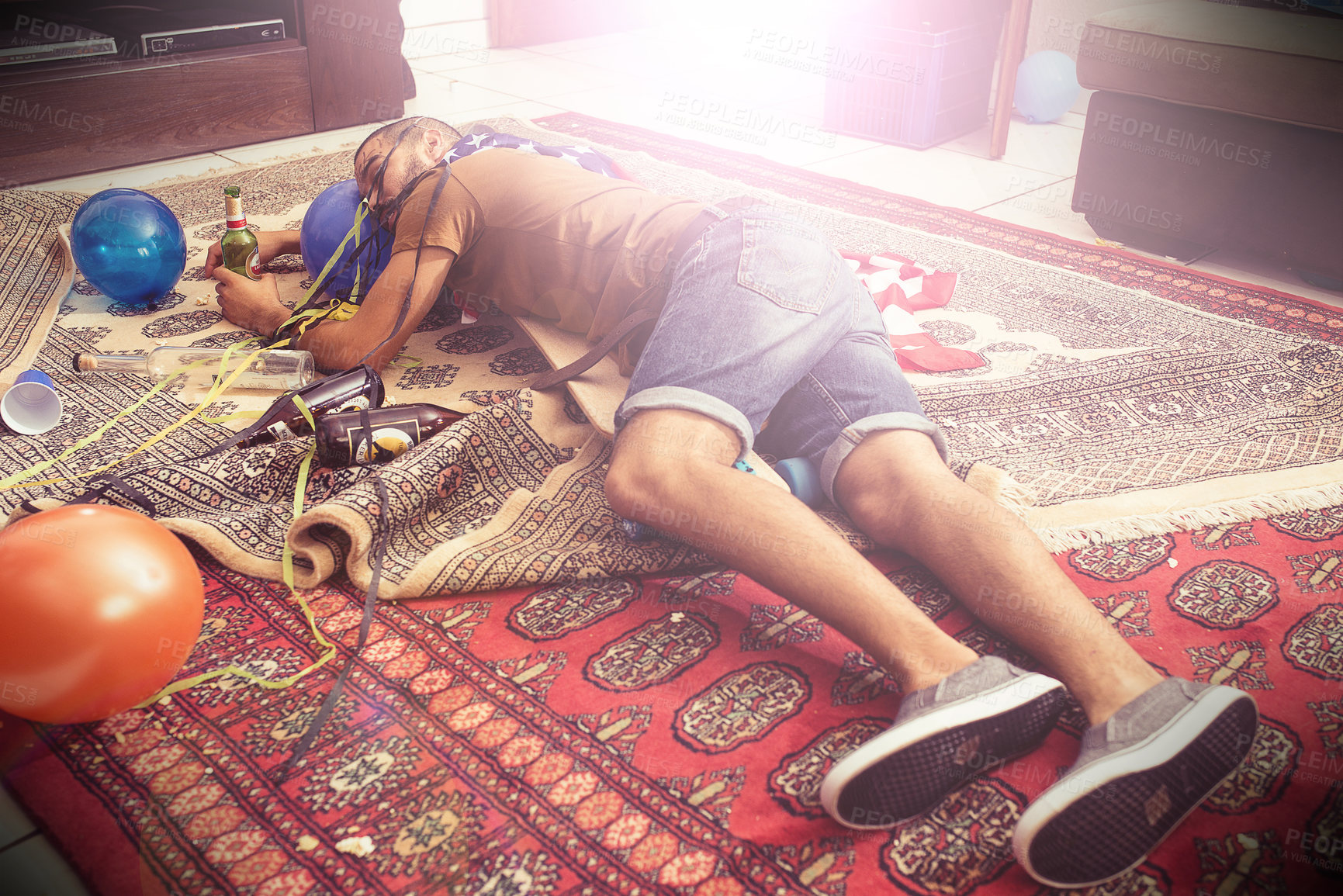 Buy stock photo Party, drunk and hangover with a man sleeping on a living room floor after new year celebration. Beer, college and hungover with a male passed out after a frat house birthday event for spring break