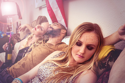Buy stock photo Drunk, sleeping and real people at a party on a sofa with a hangover from a celebration at a house. Tired, alcoholic and young man taking a nap with women on a couch at a home event in America.