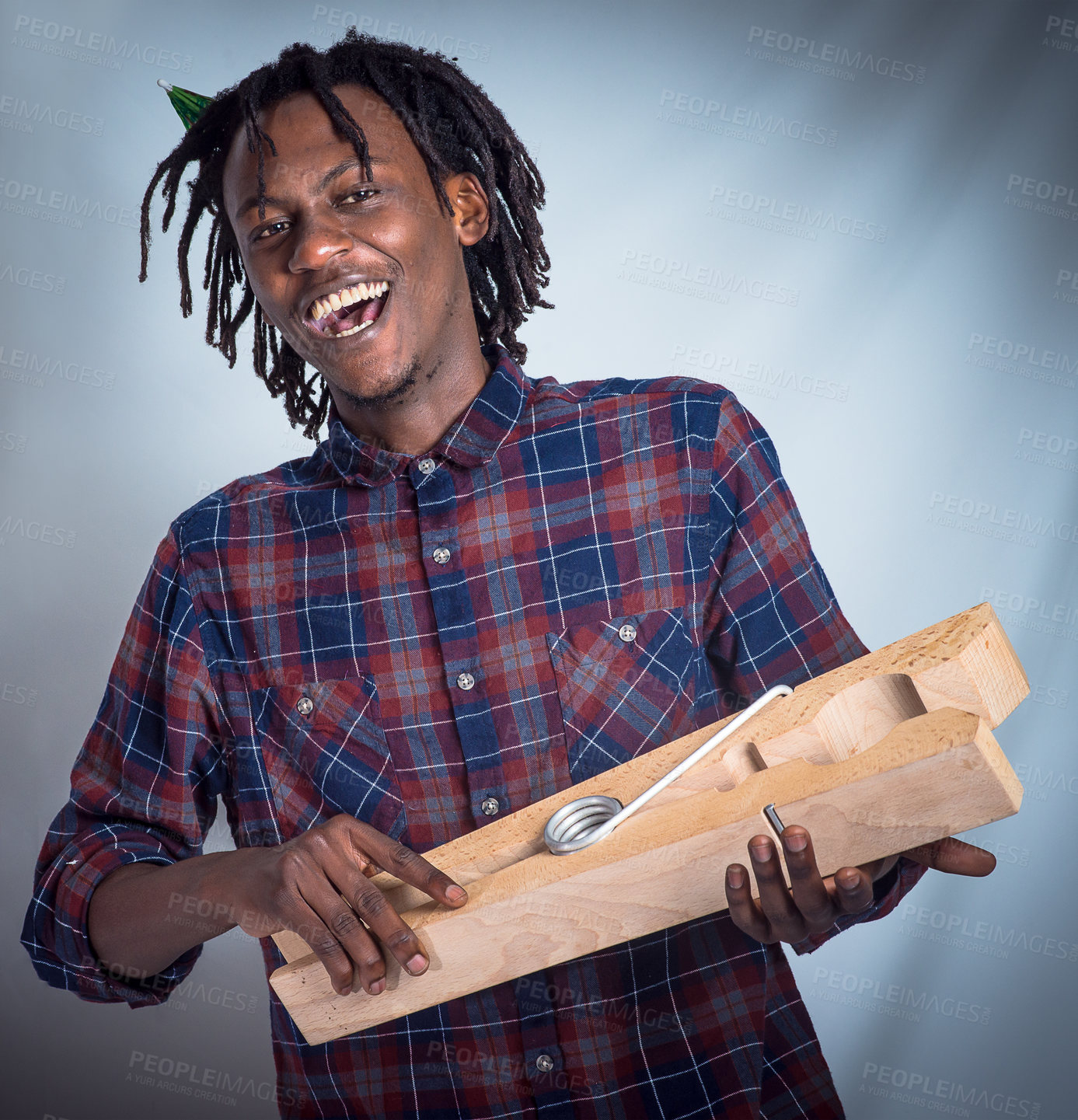 Buy stock photo Portrait, prop and happy man holding giant peg looking cheerful on a grey studio background. Face, front and laughing, joyful african american male holding a clothes peg on a studio backdrop