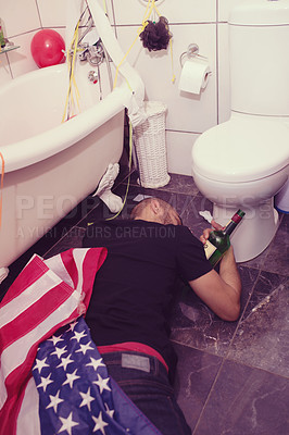 Buy stock photo Party, hangover and drunk man in bathroom sleeping after celebration, festival and house party in usa. After party, alcohol and male on floor by toilet of social event, new years eve and house party