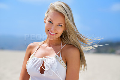 Buy stock photo Shot of a happy young woman smiling while on the beach