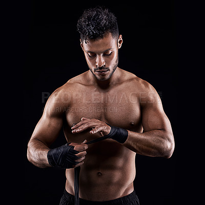 Buy stock photo Studio shot of a young boxer isolated on black