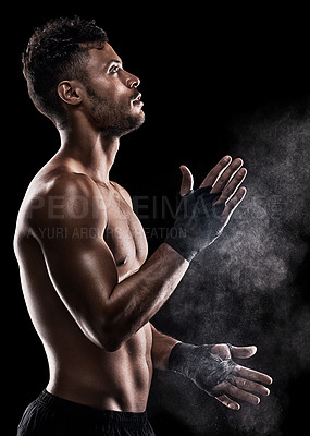 Buy stock photo Cropped shot of a man dusting powder on his hands as he prepares to box