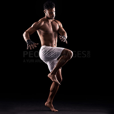 Buy stock photo Studio shot of a young boxer isolated on black