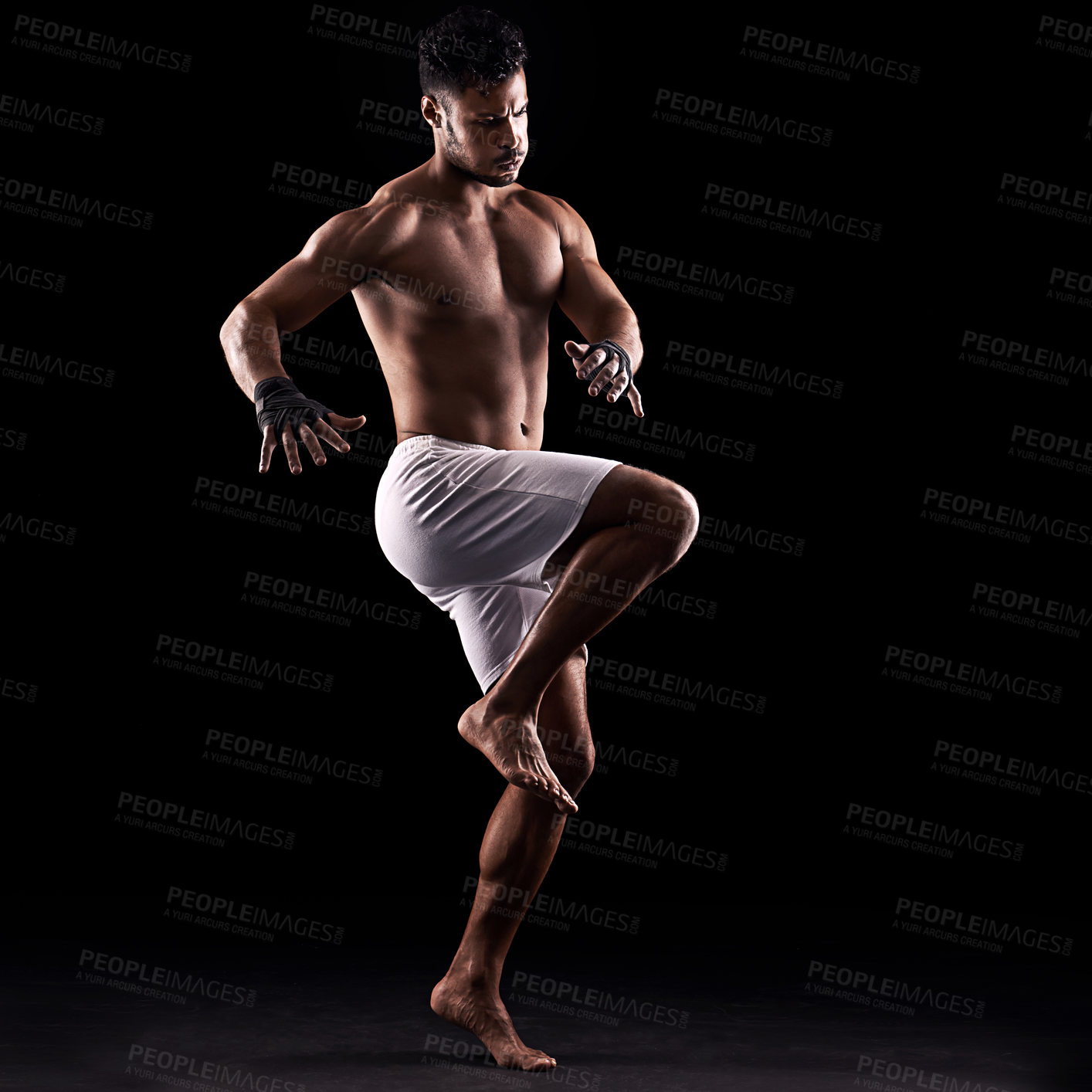 Buy stock photo Studio shot of a young boxer isolated on black