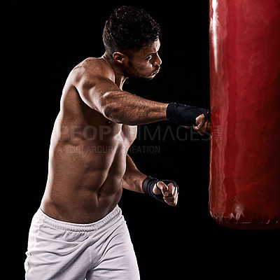 Buy stock photo Boxing, man and training in studio with punching bag for workout, exercise or competition fight with fitness. Athlete, boxer and confidence for martial arts with power and topless on black background