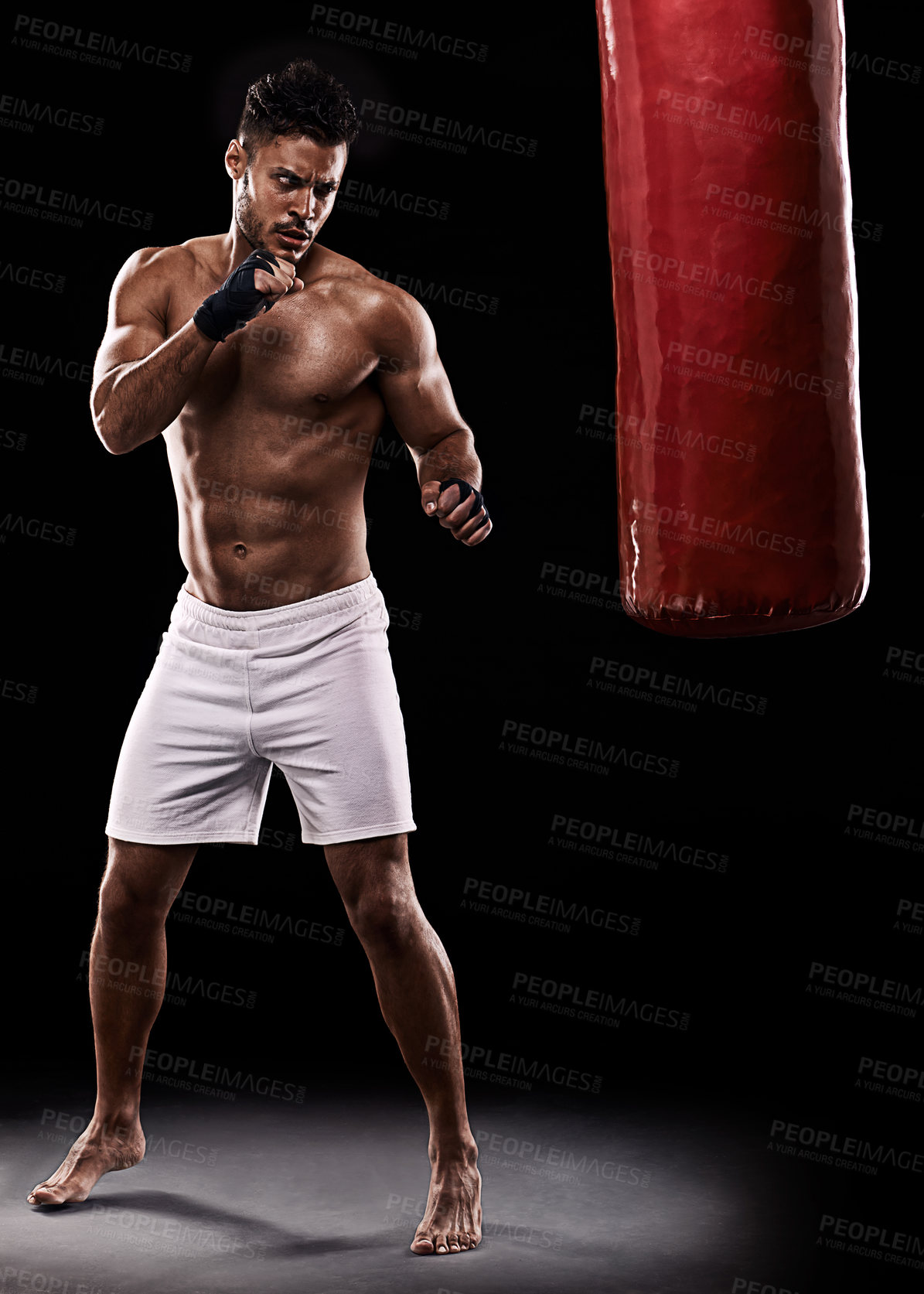 Buy stock photo Kickboxing, man or training in studio with punching bag for workout, exercise or competition fight with fitness. Athlete, boxing or serious for martial arts with muscle or topless on black background