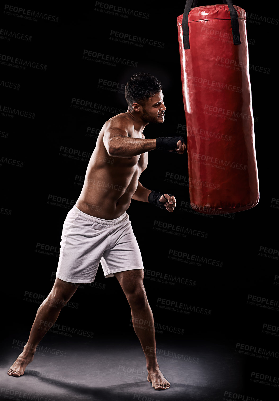 Buy stock photo Boxing, man and training in studio with punching bag for workout, exercise or competition fight with fitness. Athlete, boxer and confidence for martial arts with energy or topless on black background