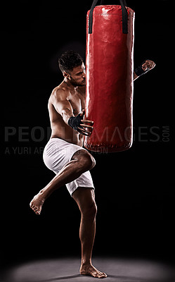 Buy stock photo Fitness, kick and punching bag by man boxer in studio for body, training or performance on black background. Impact, knee and topless athlete with martial arts, mama or kickboxing match practice