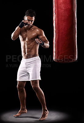 Buy stock photo Fitness, punching bag and man boxer in studio for body, training or performance on black background. Fighter, impact and topless male athlete with martial arts, mama or kickboxing match practice