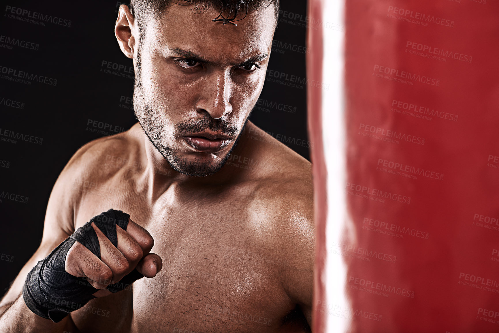 Buy stock photo Boxing, man or serious in studio with punching bag for training, exercise or competition fight with fitness. Athlete, boxer or workout for martial arts with performance or topless on black background