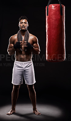 Buy stock photo Portrait, boxing bag and male boxer for break, studio and  athlete on black background. Dark, training and combat sports or MMA for man model, workout, muscle and impact activity for martial arts