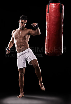 Buy stock photo Kickboxing, man and workout in studio with punching bag for training, exercise or competition fight with fitness. Athlete, boxer and strong for martial arts with power and topless on black background