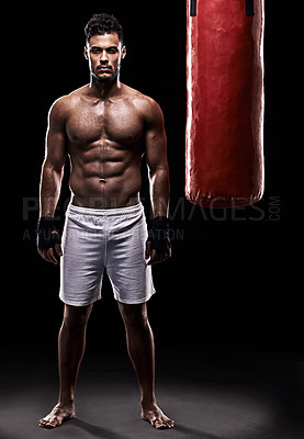 Buy stock photo Studio, boxer and portrait of man, punching bag  and gloves for training with strength and muscle. Adult, athlete and male person in dark background, healthy and power with body, job and sport