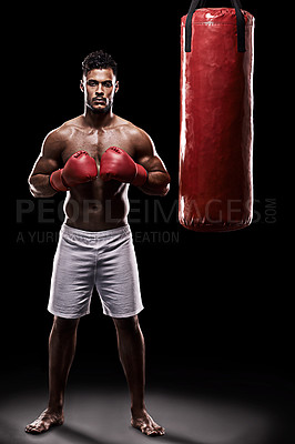 Buy stock photo Serious, boxer and portrait of man in studio with gloves for training with strength and muscle. Adult, athlete and male person in dark background, healthy and power with body, punching bag and sport