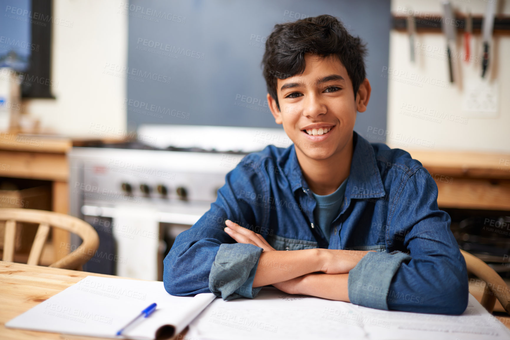 Buy stock photo Portrait of a young boy studying at a desk in a classroom