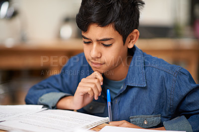 Buy stock photo Student, boy and reading in home for study with thinking, problem solving and homework assessment by table. Child, education or knowledge with books in dining room for concentration on school project