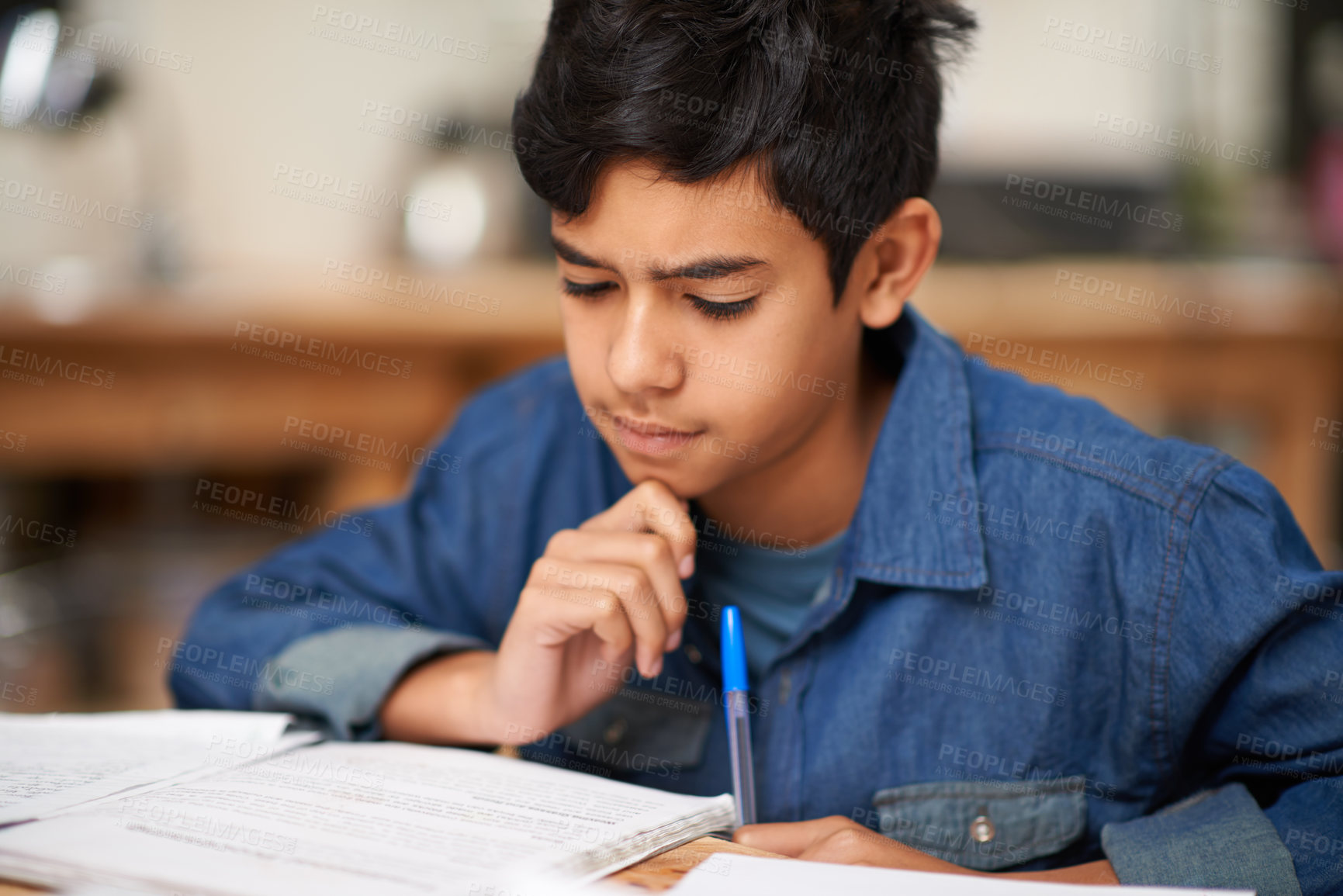 Buy stock photo Student, boy and reading in home for study with thinking, problem solving and homework assessment by table. Child, education or knowledge with books in dining room for concentration on school project