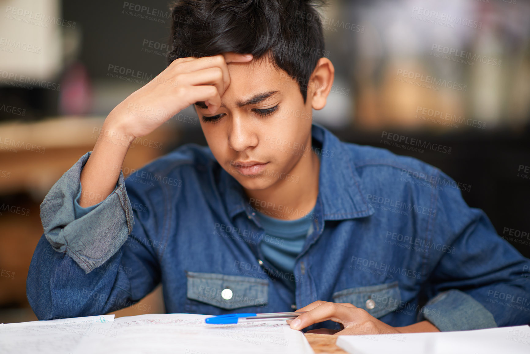 Buy stock photo Shot of a young teenage boy studying at a desk