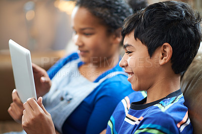 Buy stock photo Cropped shot of a little brother and sister watching something on a tablet