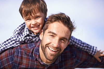 Buy stock photo Portrait, man and child with piggy back, smile and playful travel to relax on outdoor adventure. Support, face of father and son in nature for fun bonding, playing and happy trust on holiday together