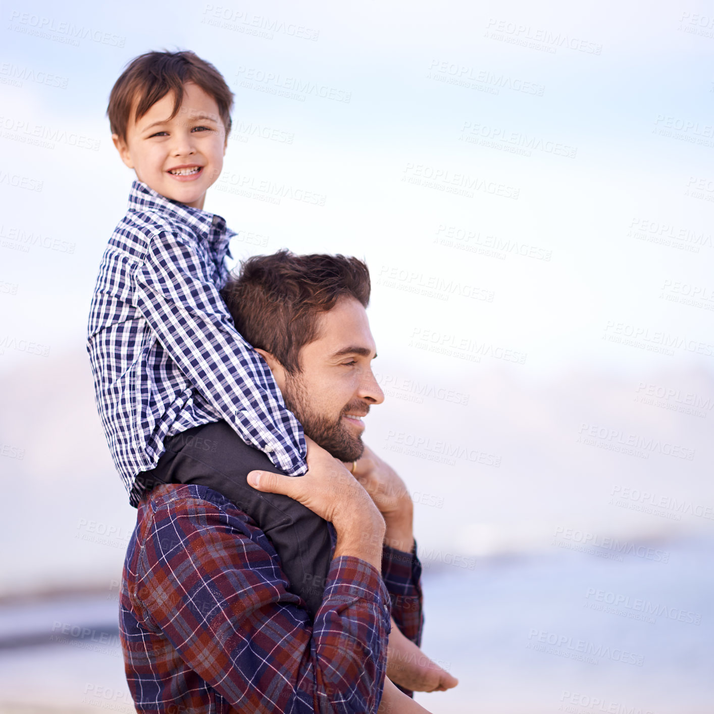 Buy stock photo Ocean, portrait and dad with child on shoulders, smile and mockup space on outdoor adventure. Support, face of father and son in nature for fun, bonding and happy trust on beach holiday together