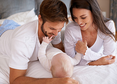 Buy stock photo Mom, dad and baby in bedroom for love, care and quality time together. Happy family, parents and newborn child relaxing on bed with smile, childhood development and support to nurture kids at home 