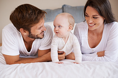 Buy stock photo Happy family, dad and mom with baby on bed for love, care and quality time together at home. Mother, father and cute newborn child relaxing in bedroom for happiness, support and development of kids 