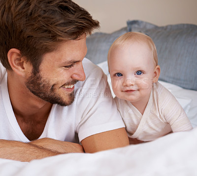 Buy stock photo Happy, sweet and baby with father on bed relaxing, playing and bonding together at home. Smile, love and young dad laying with girl child, infant or kid in bedroom or nursery at family house.