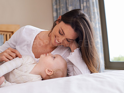 Buy stock photo Mother, playful and care with baby girl on bed for bonding, love and relax together in bedroom. Parenting, happy woman and daughter for childhood development, support and nursery in apartment