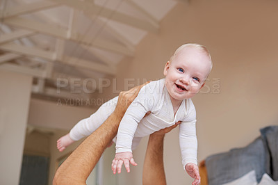 Buy stock photo Bedroom, playing and parent with baby in air for family fun, bonding and relax together in home. Happy, smile and newborn infant with father for child development, support and happiness in house