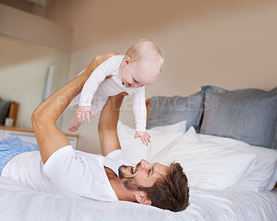 Buy stock photo Love, smile and baby with father on bed relaxing, playing and bonding together at home. Happy, sweet and young dad laying with girl child, infant or kid in bedroom or nursery at family house.