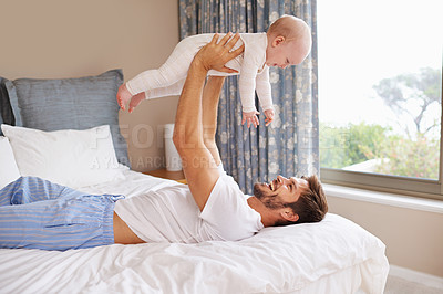 Buy stock photo Happy, laughing and baby with father on bed relaxing, playing and bonding together at home. Smile, love and young dad holding girl child, infant or kid in bedroom or nursery at family house.