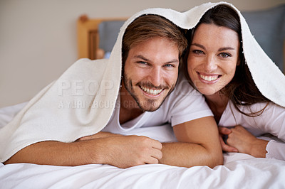 Buy stock photo Couple, bedroom and smile with towel to relax for bonding, love and support on break together. Portrait, relationship and romance with happiness or fun at home as family, soulmate and lying in bed