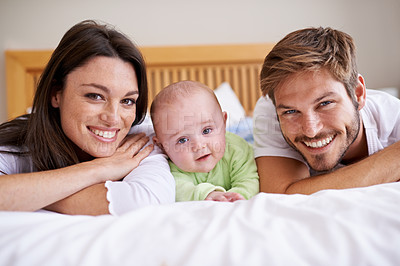 Buy stock photo Happy portrait of mother, father and baby on bed for love, care and fun quality time together at home. Parents, cute newborn child and family bonding to relax in bedroom for support, happiness or joy