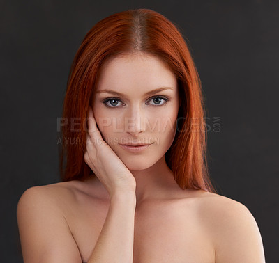 Buy stock photo Portrait of a gorgeous young redheaded woman against a black background