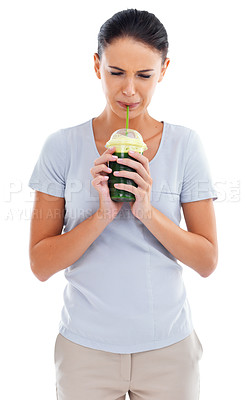 Buy stock photo Woman, green smoothie and drinking or unhappy in studio, nutrition and raw herb taste on white background. Female person, diet and milkshake for weight loss or detox, minerals and disgusting fiber