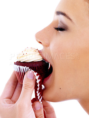 Buy stock photo Studio, woman and eating cupcake with happiness for nutrition, satisfaction and unhealthy snack. Female person, food and sweet dessert with red velvet, enjoyment and tasty muffin on white background