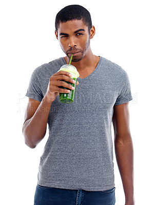 Buy stock photo Man, portrait and green smoothie in studio, nutrition and wink for juice on white background. Black male person, balanced diet and milkshake for weight loss or detox, minerals and organic fiber