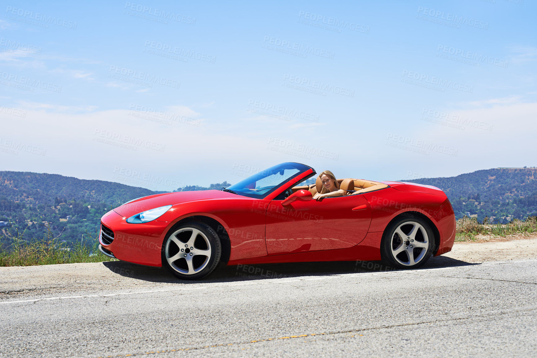 Buy stock photo Woman, red convertible and road trip on mountain, travel and luxury transport on summer drive. Happy female person, holiday and countryside wellness on street, vacation and adventure in vehicle