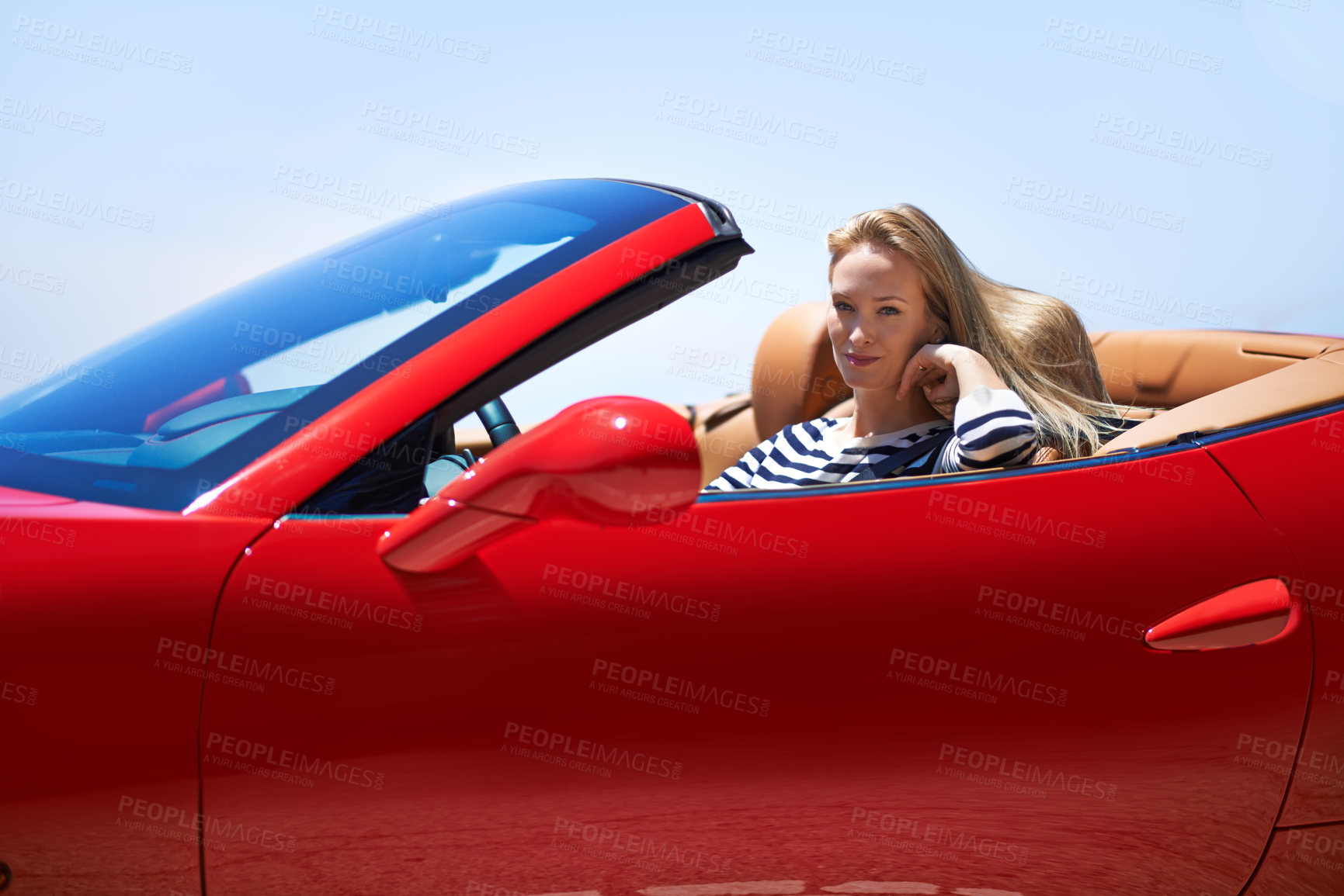 Buy stock photo Shot of a young woman driving in a sports car