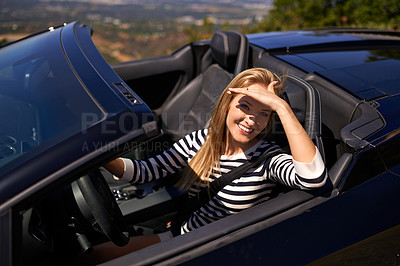 Buy stock photo Shot of a young woman driving in a sports car