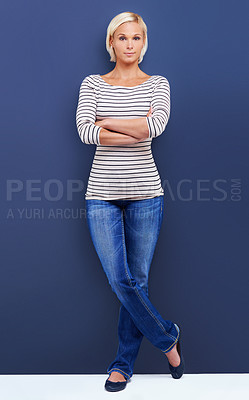 Buy stock photo Portrait, arms crossed and serious woman in studio for fashion isolated on a blue background mockup space. Confidence, blonde and female person in casual clothes or jeans on a backdrop in Switzerland