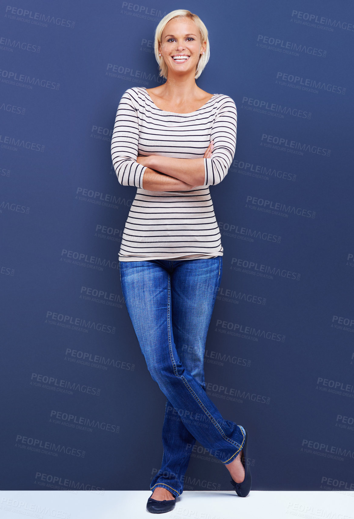 Buy stock photo Portrait, arms crossed and happy woman in studio for fashion isolated on a blue background mockup space. Confidence, blonde and funny person in casual clothes or jeans on a backdrop in Switzerland