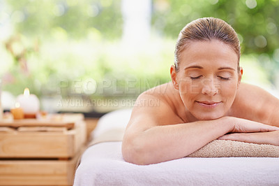 Buy stock photo Happy woman, sleeping and relax with towel for spa, zen or massage table at hotel or outdoor resort. Face of female person with smile or enjoying peaceful body treatment at accommodation for wellness
