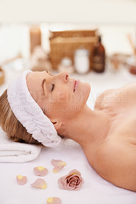Buy stock photo Woman, spa and rest for zen, peace and wellness with relaxation and calm. Lady, towel and massage table at resort, lounge or luxury parlor with rose for holistic body and skincare for detox and break