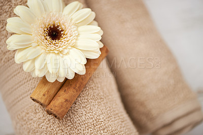 Buy stock photo Detail, closeup and flower on towel in spa for luxury service in hospitality at hotel on holiday or vacation. Floral, cinnamon and offer object in accommodation for wellness treatment on table